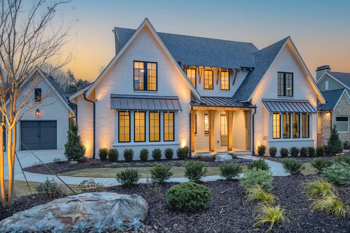 atlanta custom home front exterior photo with lights on at dusk