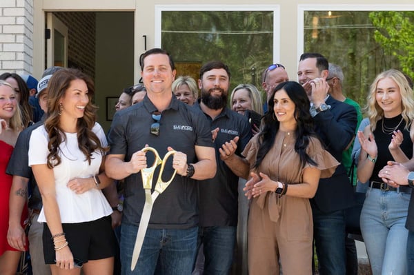 Elevation building company team cutting ribbon