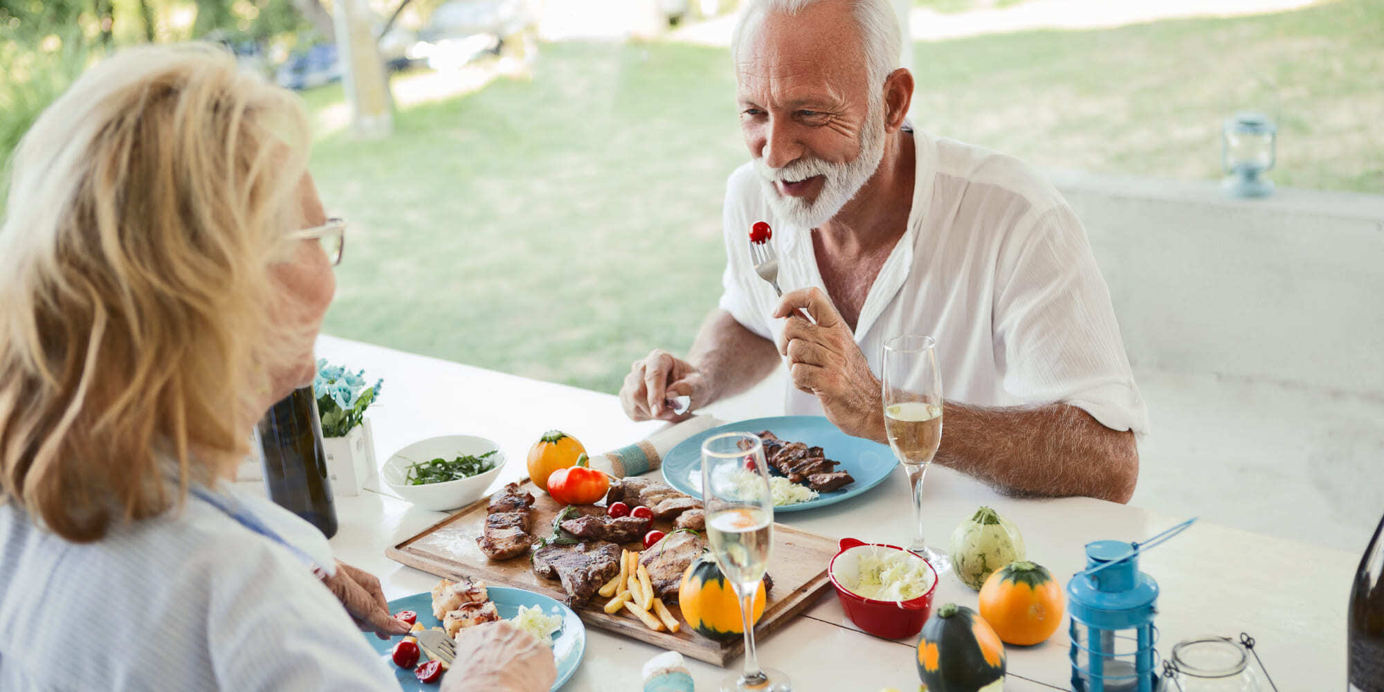 Mature couple dining outdoors, enjoying relaxed luxury lifestyle | Why Atlanta is a hotspot for luxury homes | Elevation Building Company